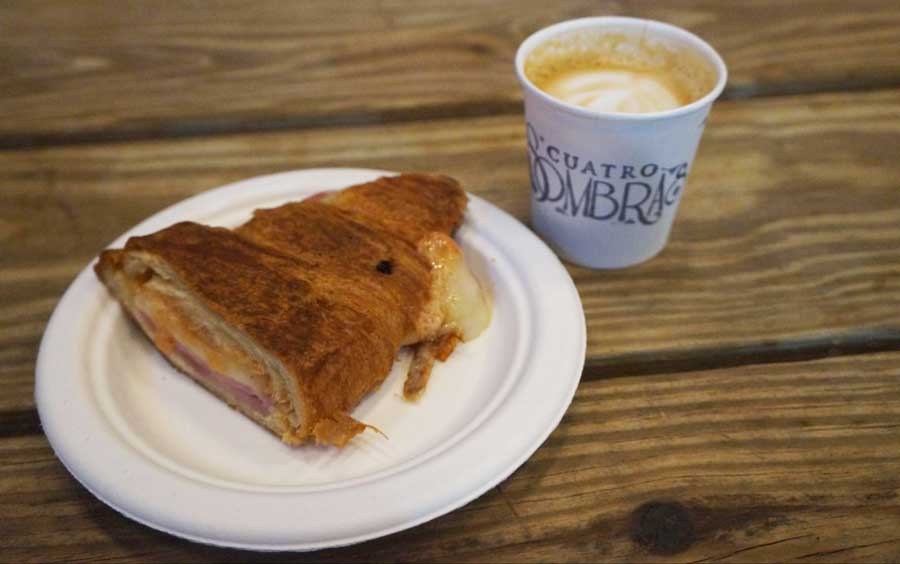 Un pastel y una taza de café de Cuatro Sombras